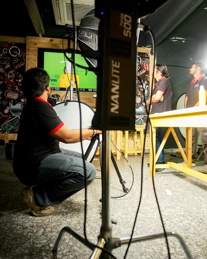 DCOP crew preparing lights, camera settings and a product set for a commercial video shoot