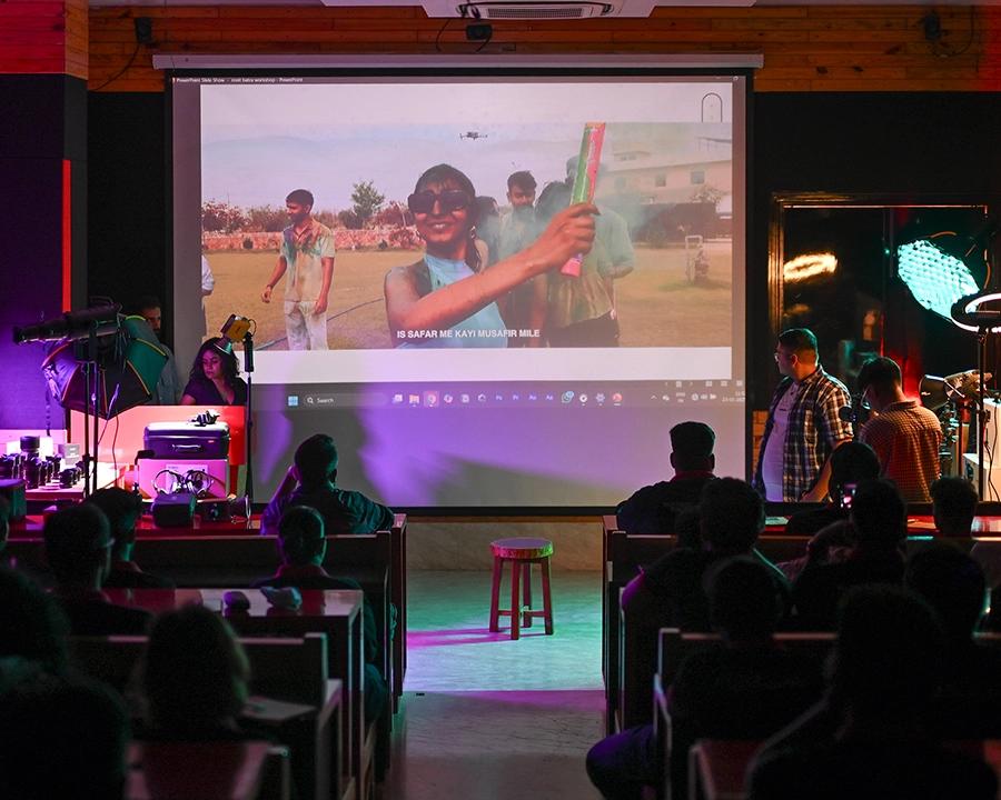 Fashion production workshop presented to students with studio lighting equipment in use
