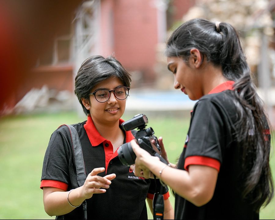 DCOP students reviewing camera settings during an outdoor photography practical