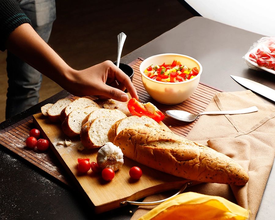 Bread, tomatoes and ingredients arranged for a Foundation Pro food photography practical