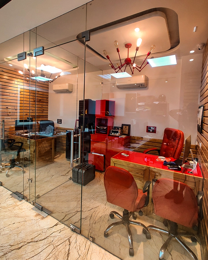 Glass-fronted counselling rooms with desks and visitor seating at the DCOP Delhi campus